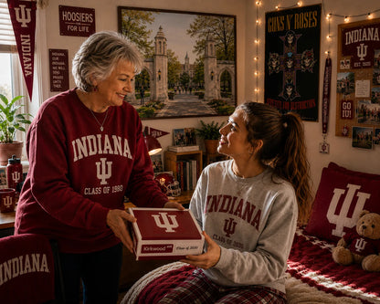 Grandmother giving a handcrafted Indiana University keepsake box to her granddaughter.
